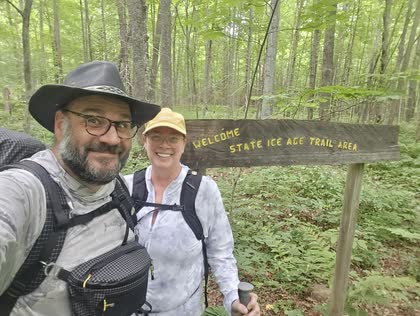 Scott and Gerrie hiking by an Ice Age Trail sign